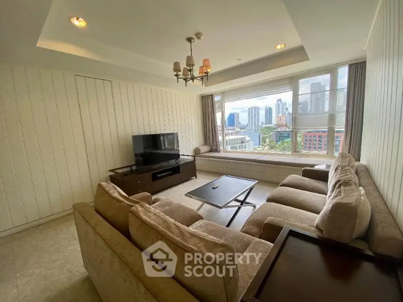 Spacious living room with city view, featuring plush sofas and modern decor in a high-rise apartment.