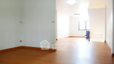 Spacious and bright interior with wooden flooring and ample natural light.