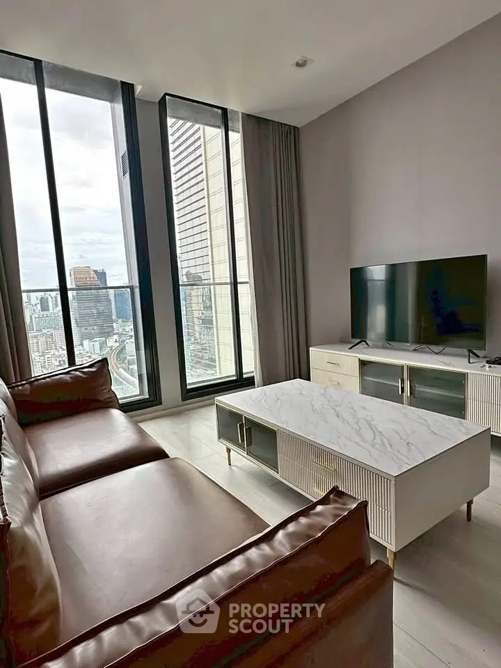 Luxurious living room with stunning city view and modern furnishings.