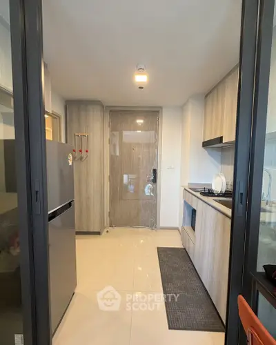 Modern kitchen with sleek cabinetry and gas stove in a contemporary apartment.