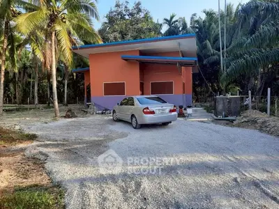 Charming rural property with vibrant exterior and lush surroundings, perfect for serene living.