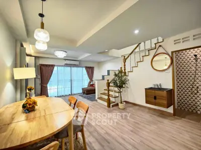 Spacious modern living and dining area with stylish decor and wooden flooring