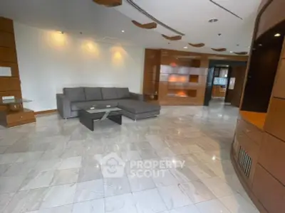Spacious modern living room with sleek furniture and elegant marble flooring.