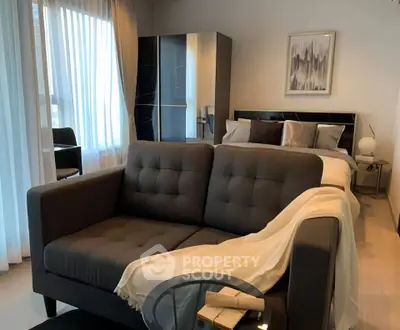 Stylish modern bedroom with cozy sofa and elegant decor