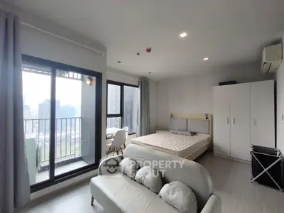 Spacious modern studio apartment with balcony and city view