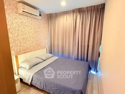 Cozy bedroom with floral wallpaper and elegant curtains in modern apartment.