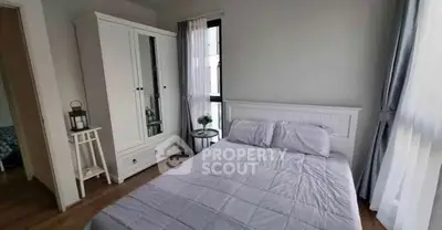 Cozy bedroom with white wardrobe and large windows for natural light