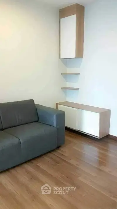 Modern living room with sleek wooden flooring and minimalist furniture design.