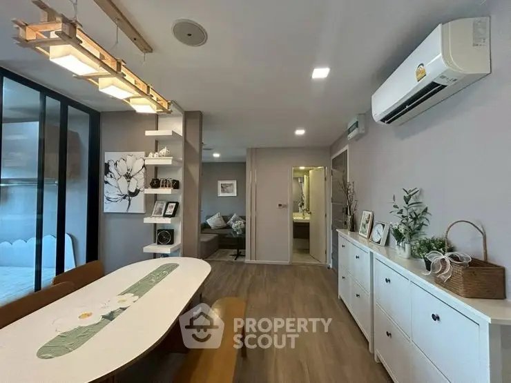 Modern open-plan living and dining area with stylish decor and air conditioning.