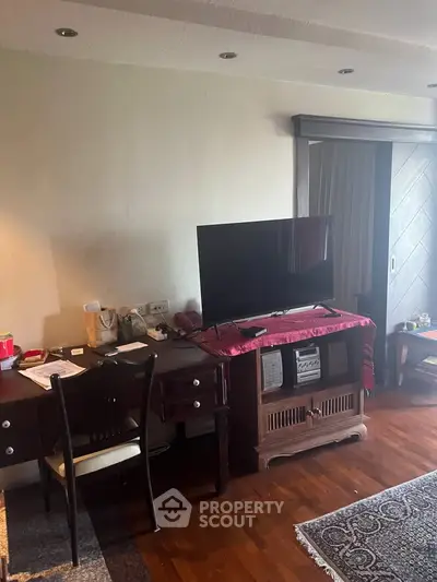 Cozy living room with wooden flooring and modern TV setup