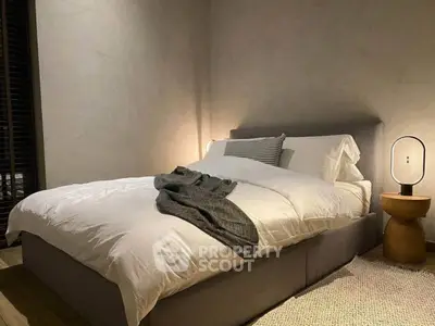 Cozy modern bedroom with stylish lighting and plush bedding
