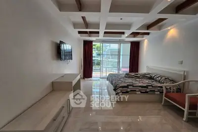 Spacious bedroom with modern decor and balcony access in luxury apartment