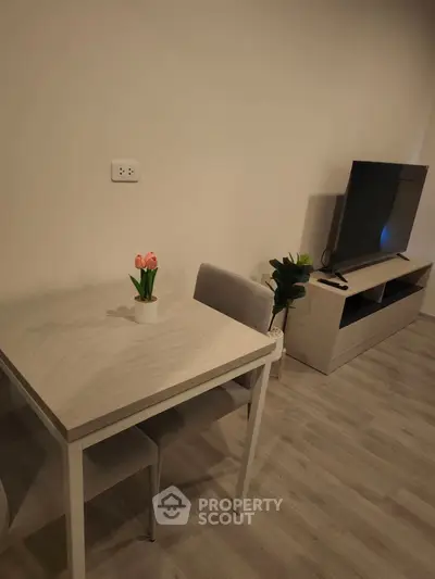 Modern living room with sleek furniture and flat-screen TV, perfect for cozy urban living.