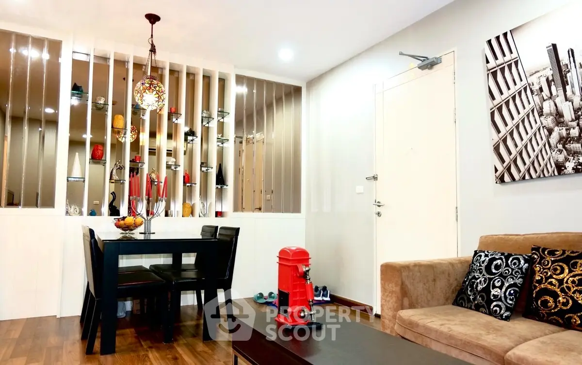 Stylish modern living room with elegant decor and dining area, featuring warm lighting and contemporary furniture.