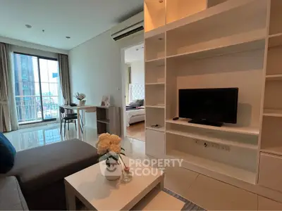 Modern living room with open layout and city view, featuring cozy sofa and stylish decor.