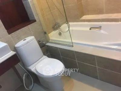 Modern bathroom with bathtub and sleek fixtures in a stylish home.