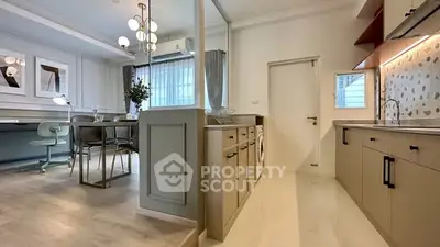 Modern kitchen and dining area with stylish decor and ample natural light.