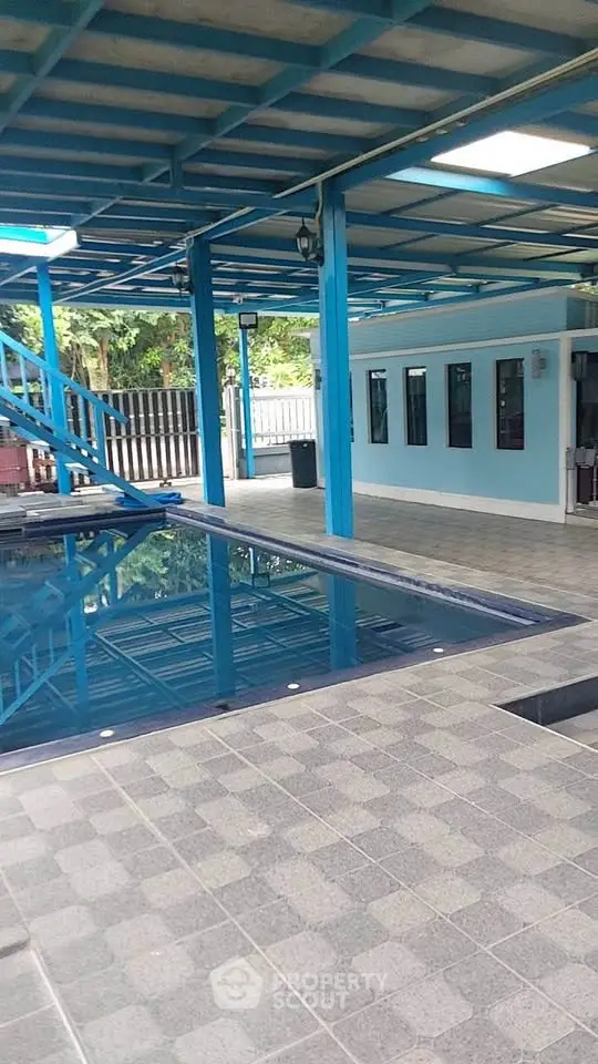 Spacious covered pool area with modern design and ample natural light.