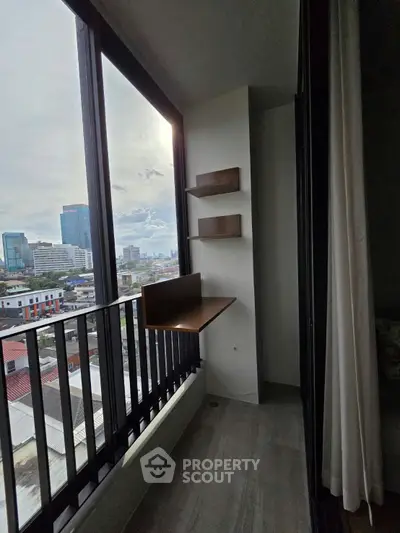 Modern high-rise balcony with city view and wooden shelves
