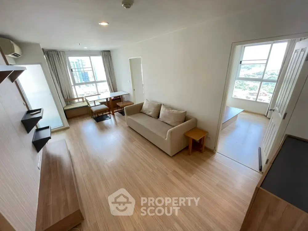 Spacious modern living room with natural light and wooden flooring