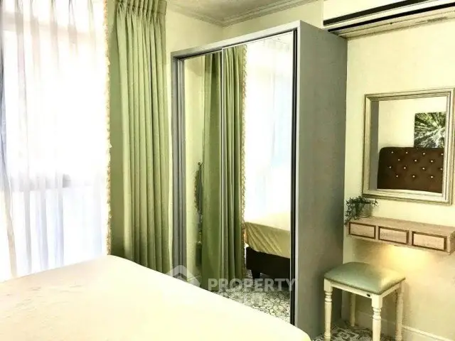 Charming bedroom with mirrored wardrobe and elegant decor