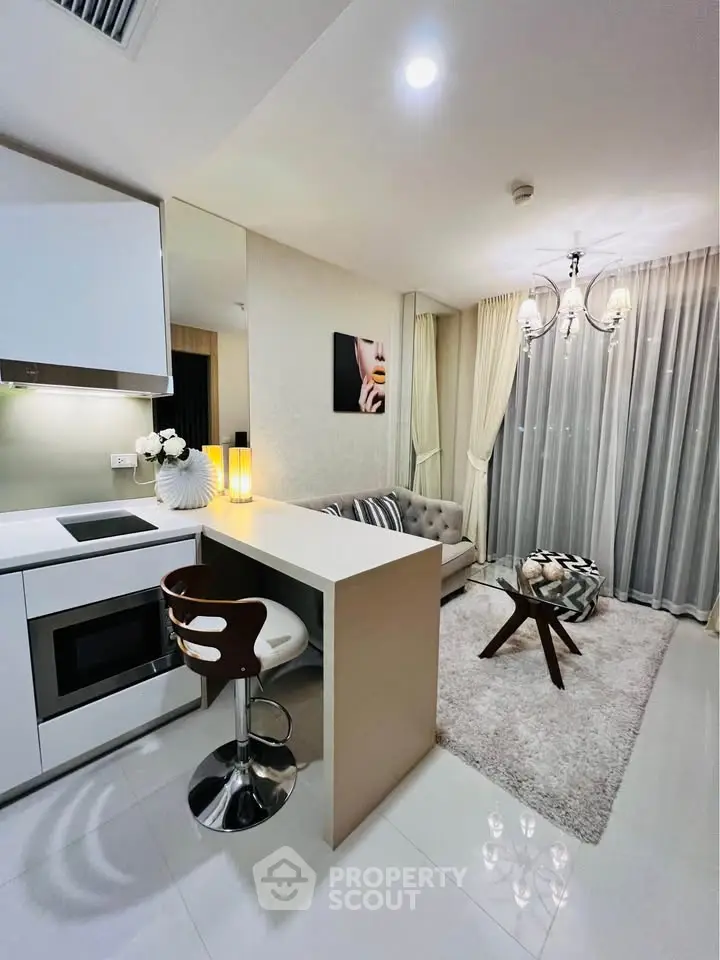 Modern open-layout living room with stylish kitchen and cozy seating area