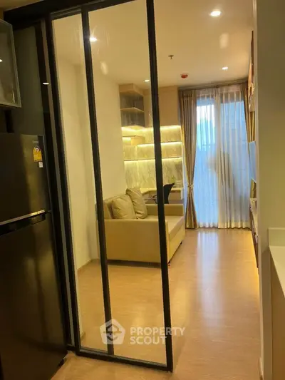 Modern living room with glass partition and cozy seating area