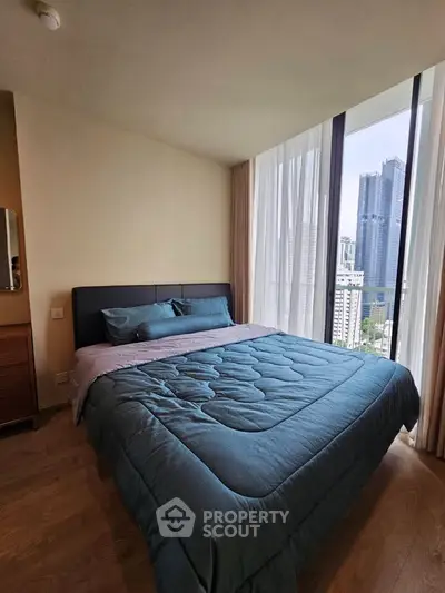 Modern bedroom with city view and large windows in a high-rise apartment.