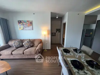 Stylish living room with cozy sofa and elegant dining area in modern apartment.