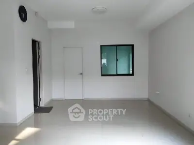 Spacious empty room with glossy tiled floor and window, ideal for customization.