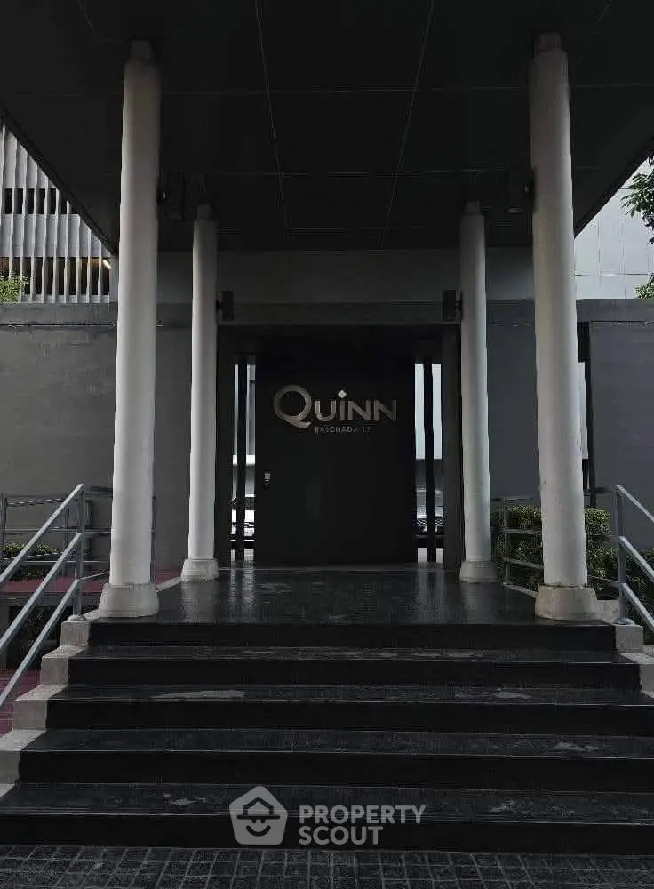 Elegant entrance of modern building with sleek design and welcoming ambiance.