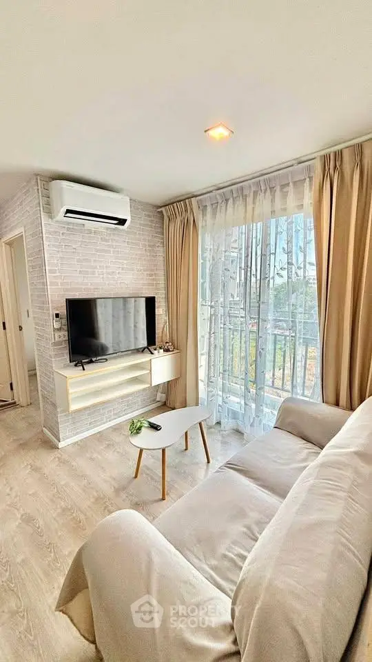 Bright and cozy living room with modern decor and large window view.