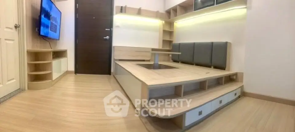 Modern living room with built-in seating and sleek wooden flooring