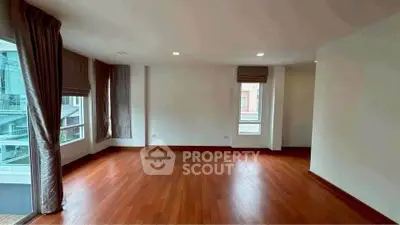 Spacious corner unit with hardwood floors and large windows.