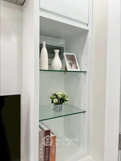 Elegant built-in shelving with decorative vases and books in modern interior design.