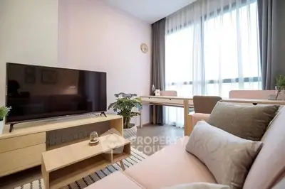 Modern living room with stylish furniture and large window, perfect for relaxation.