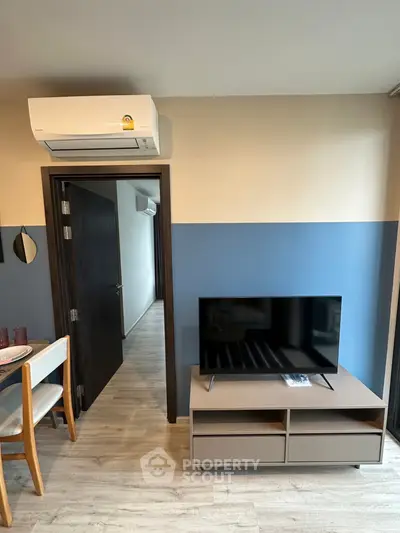 Modern living room with air conditioning and flat-screen TV