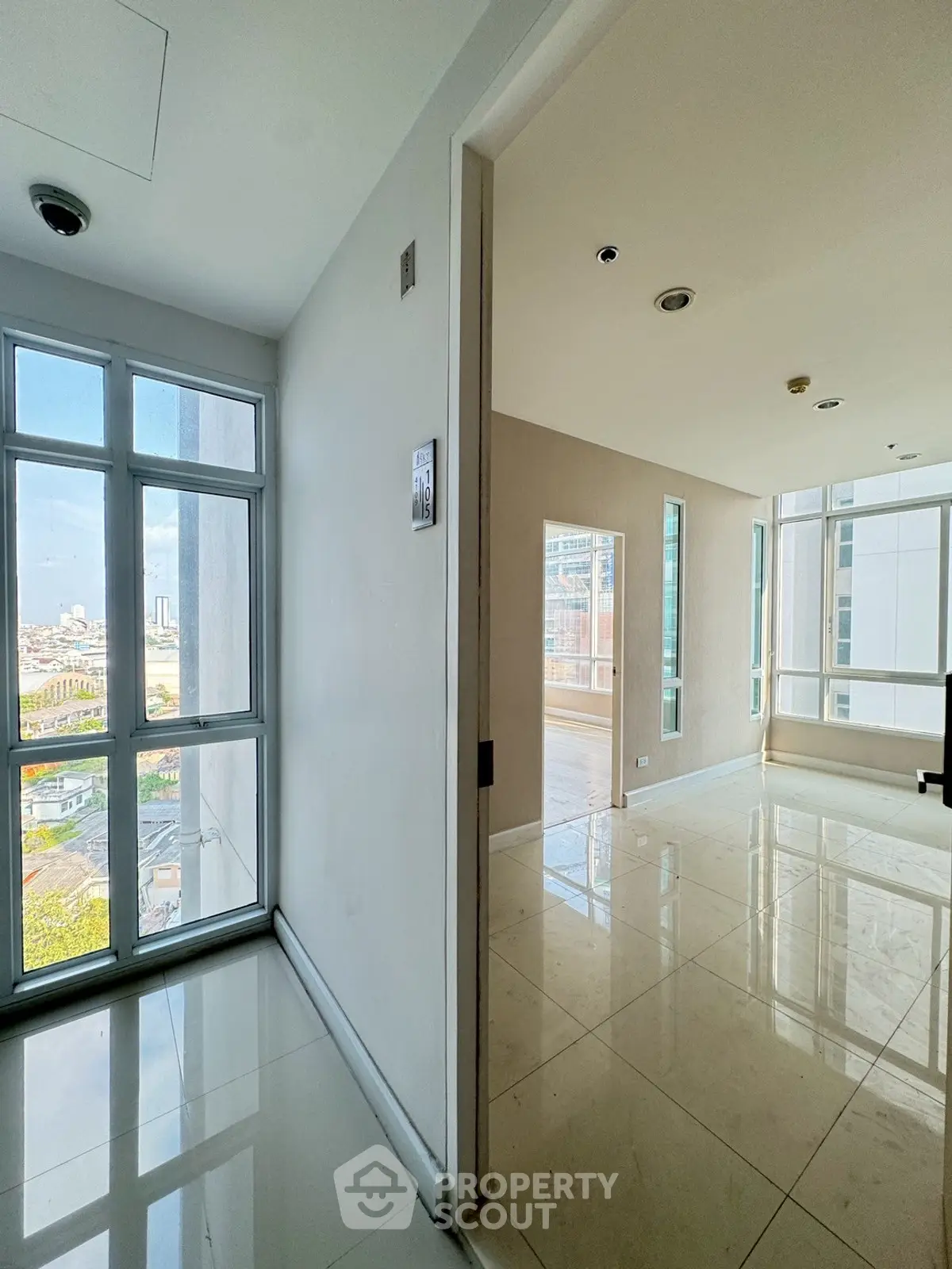 Spacious corner unit with floor-to-ceiling windows offering stunning city views and abundant natural light.