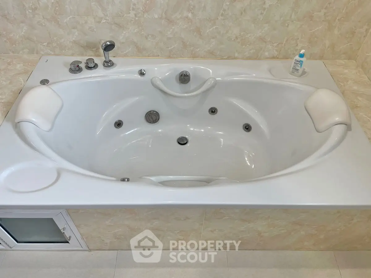 Luxurious bathroom with elegant jacuzzi tub and marble accents