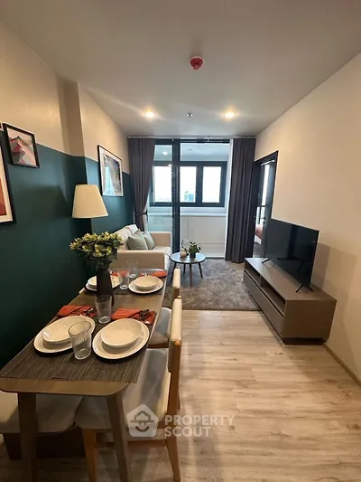 Modern living room with dining area, stylish decor, and natural light.