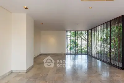 Spacious modern living room with large windows and garden view, perfect for natural light lovers.