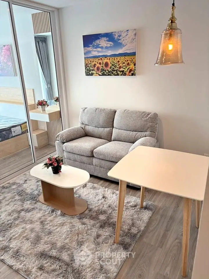 Charming living room with cozy sofa, modern decor, and natural light in a stylish apartment.