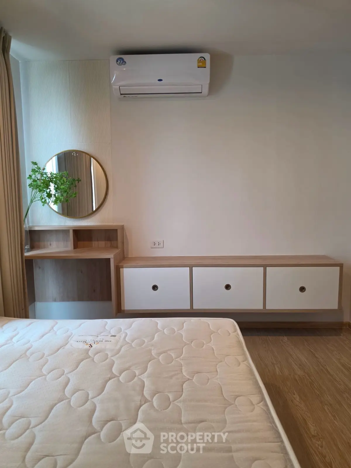 Modern bedroom with air conditioning and stylish wooden furniture