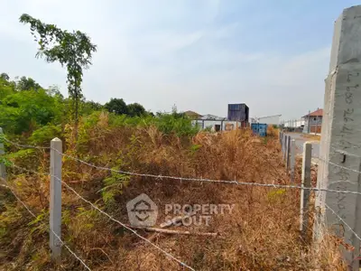 Vacant land plot with boundary fencing and natural vegetation, ideal for development opportunities.