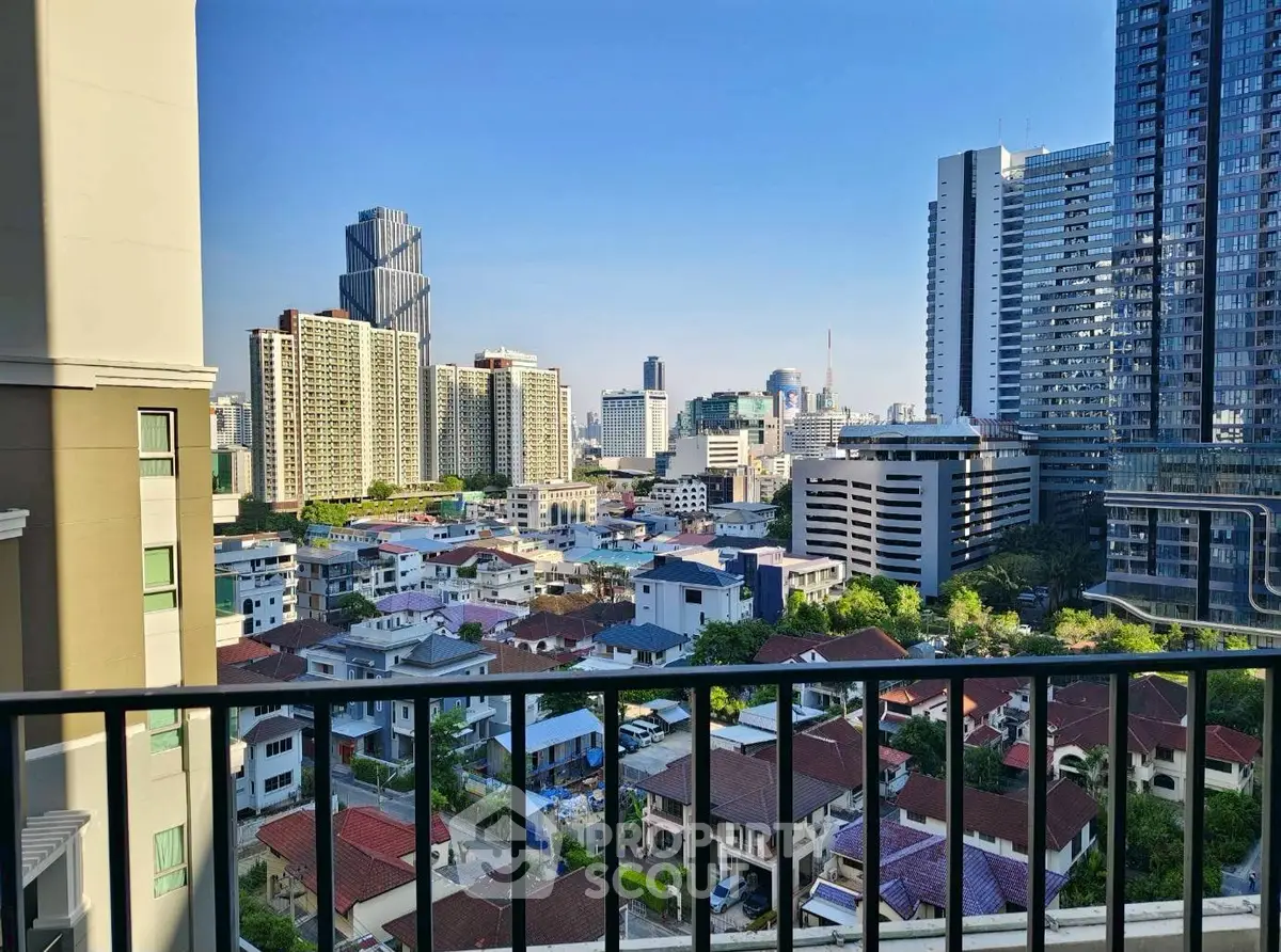 Stunning cityscape view from a high-rise balcony showcasing urban skyline and residential area.