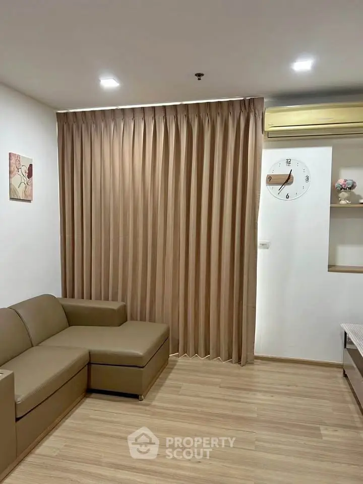 Modern living room with sleek sofa and elegant curtains in a cozy apartment.