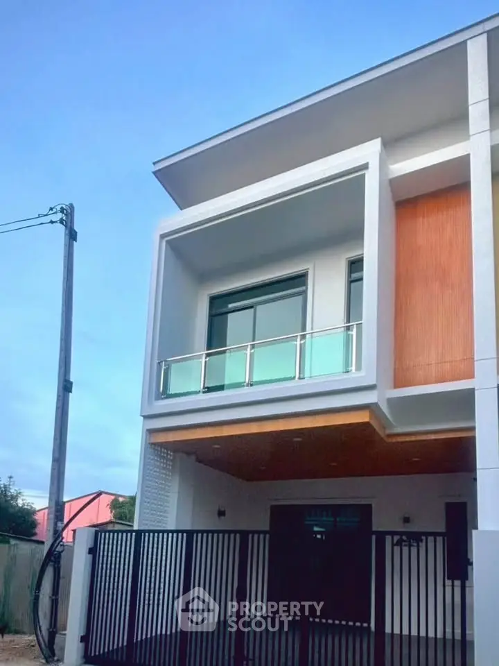 Modern two-story house with sleek balcony and contemporary design
