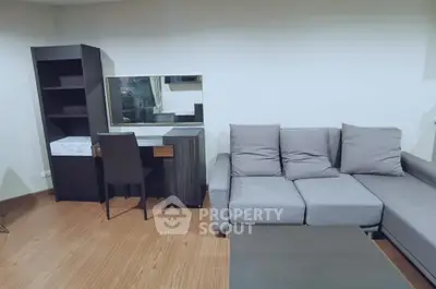 Modern living room with stylish gray sofa and sleek desk setup