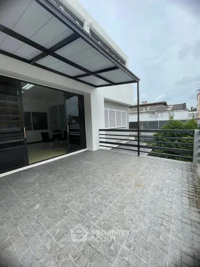 Spacious balcony with modern railing and tiled flooring, perfect for outdoor relaxation.