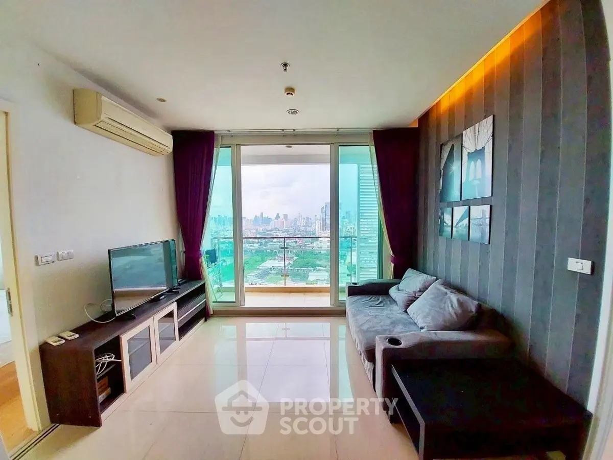 Modern living room with city view, featuring sleek furniture and large windows for natural light.